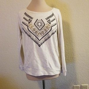 White top with black and gold embellishments